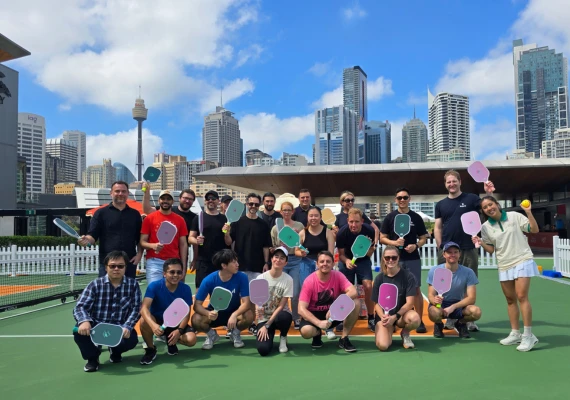 Team members playing pickleball